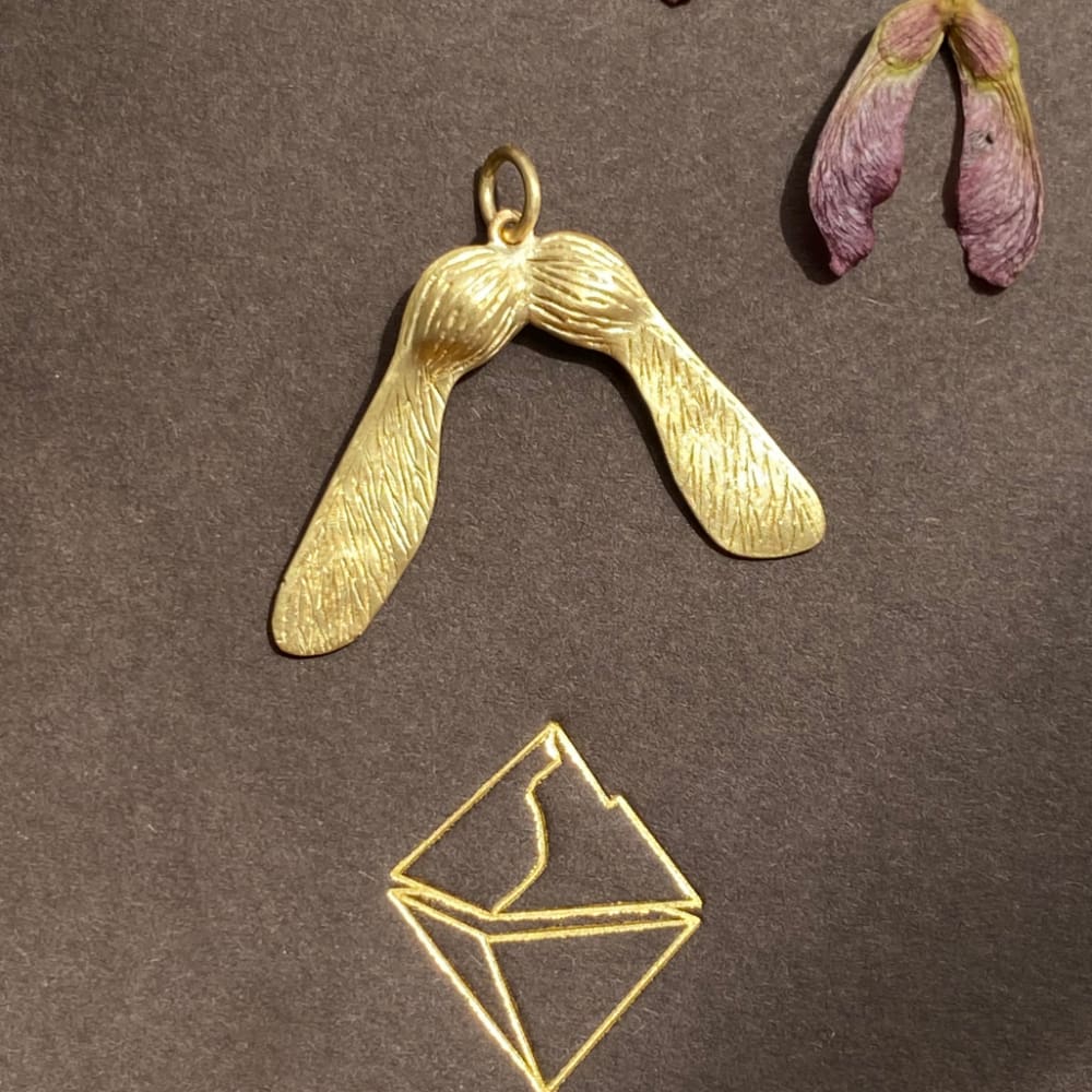 Designed as an 18K gold maple key. The sugar maple is a sacred tree for the people of the First Nations. Read more about this MAGIC tree in Robin Wall Kimmerer's ﻿Braiding Sweetgrass: Indigenous Wisdom, Scientific Knowledge and the Teachings of Plants.  ﻿This pendant is entirely handmade here in NYC an will ship in 1 week. 