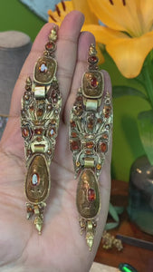 A pair of 18th century Iberian hessonite and gold ear pendants known as Arracades d'arengada, or herring earrings, for their resemblance to an elongated fish shape.